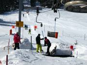 Am Schlepplift wird beim Einsteigen geholfen