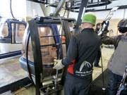 Der Liftangestellte nimmt die Ski ab